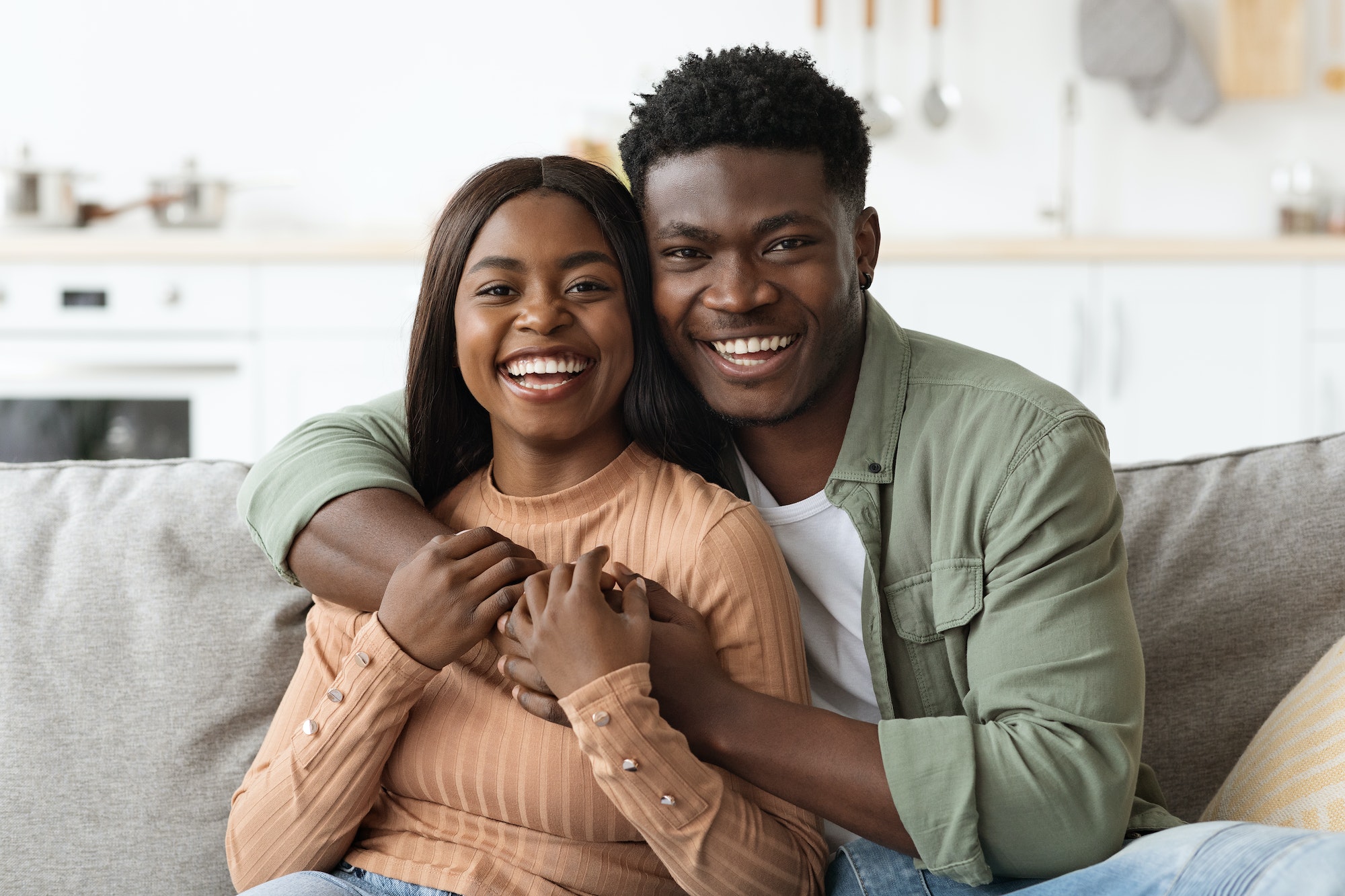 Closeup portrait of happy black couple, home interior